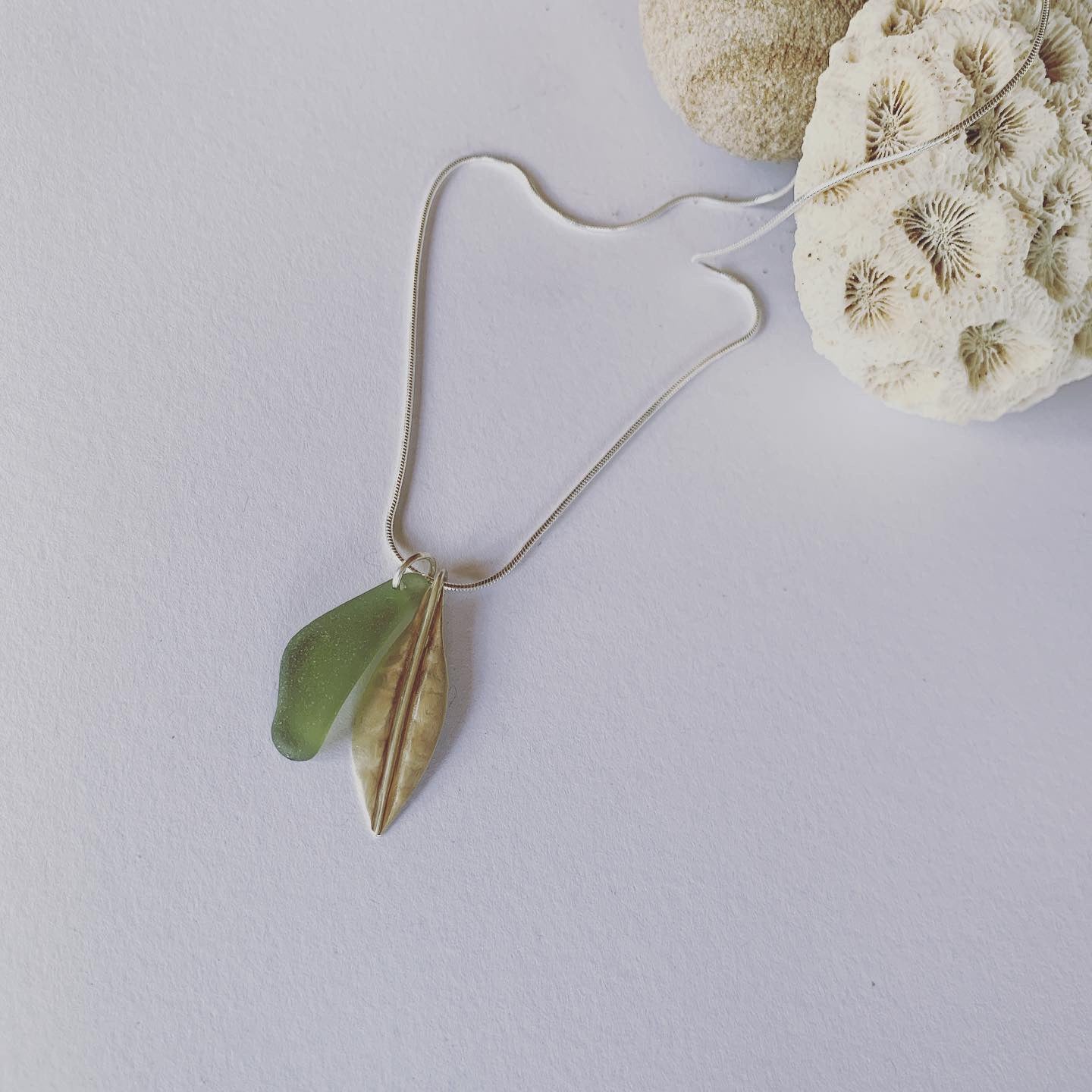 Silver leaf and beach glass pendant. Naturally ocean tumbled beach glass and silver leaf pendant on sterling silver snake chain..... available in 45cm and 50cm sterling silver snake chain. Ocean and Earth🌊🍃 Each piece of natural beach glass may slightly vary, as no piece of beach glass is the same. Unique and of the same quality only the most perfect shaped pieces are used to suit the design and how each piece sits.