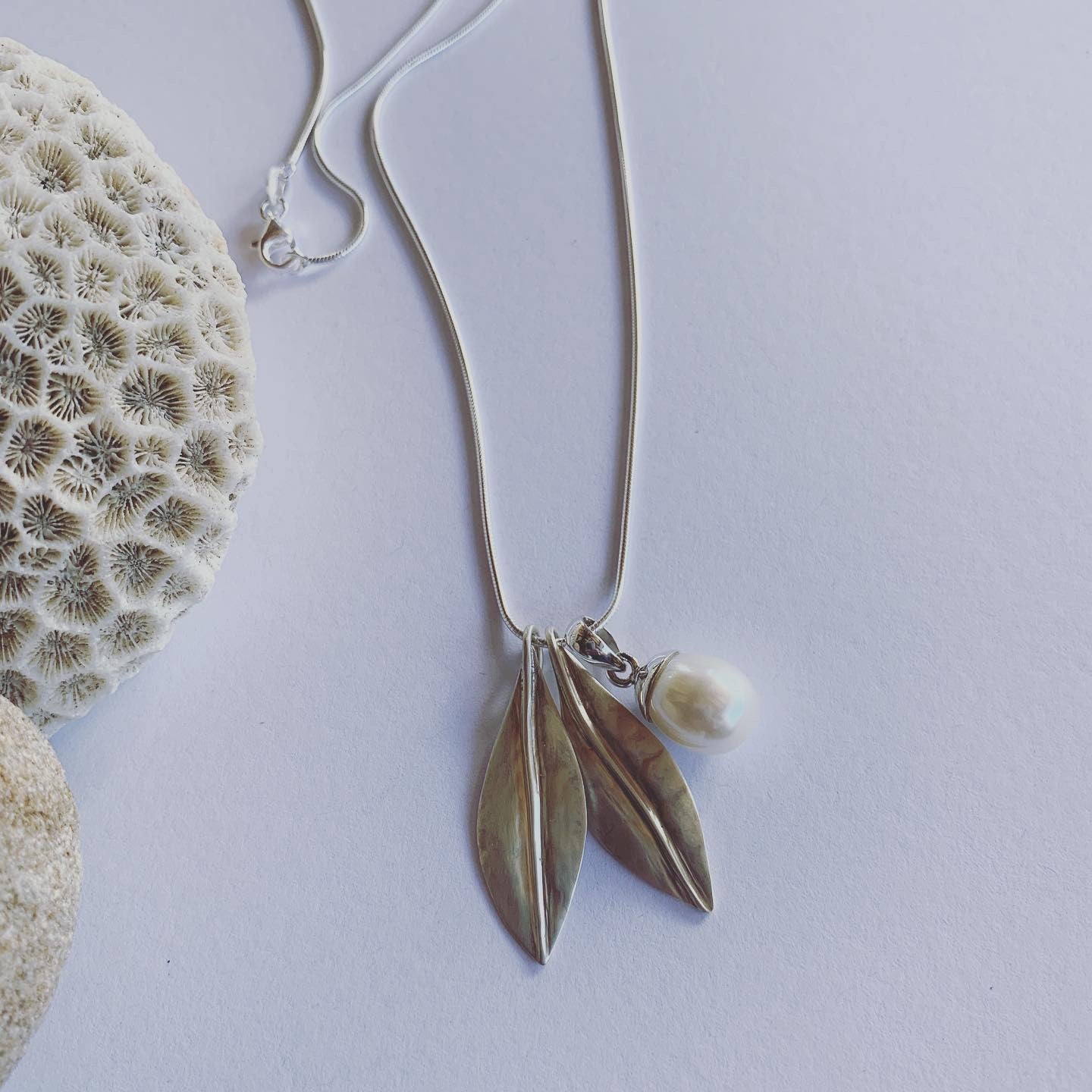 Handmade in silver our special, two leaf and white pearl pendant on sterling silver snake chain. Available on 45cm and 50cm snake chain. The charm of earthly delights, where forest and ocean meet, on the gorgeous snake chain🌿