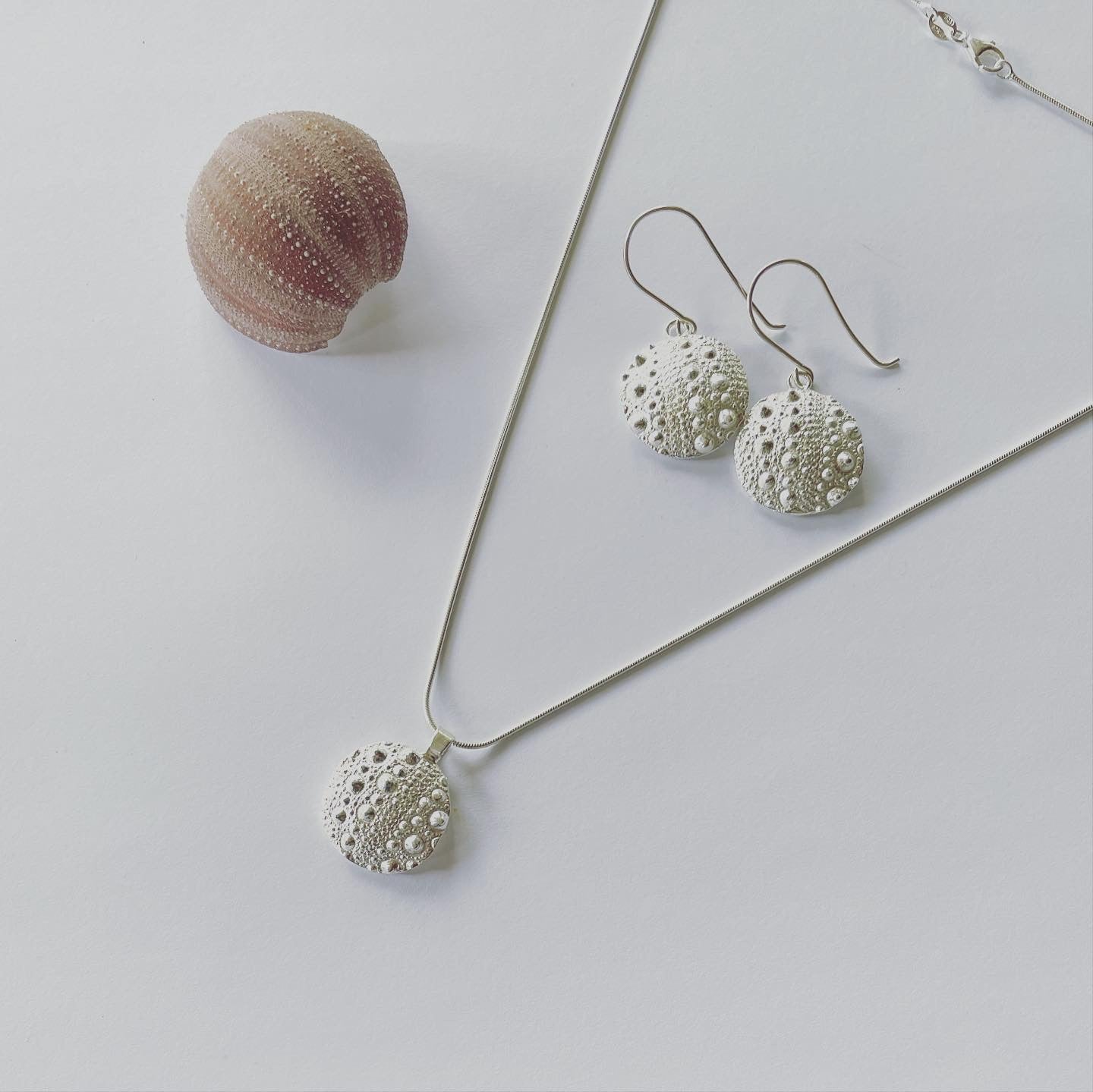 Honouring the beautiful Sea Urchin form of creation. Re-created with this stunning Neive pendant in sterling silver on sterling silver snake chain. The Sea Urchin is said to be the seer. The Sea Urchin symbolises “seeing” with your inner eye.