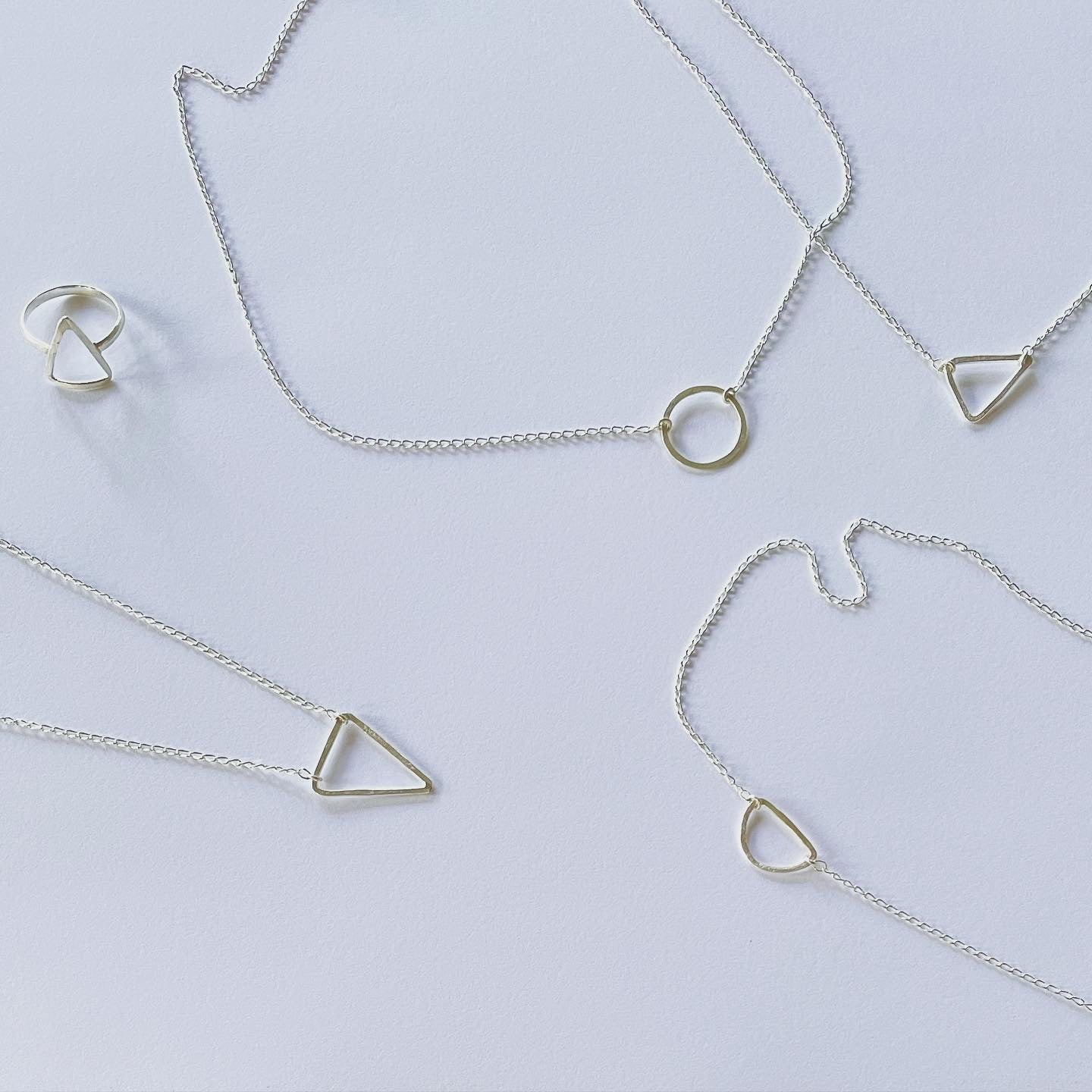 The Trinity pendant, the triangle pendant in silver. Part of our geometric series, half moon, triangle and ring pendant. Connection to our earth and heart space of creation in sacred geometry. A triangle represents manifestation, enlightenment, revelation, and a higher perspective. Energetically, triangles direct energy and power in the direction which they point.