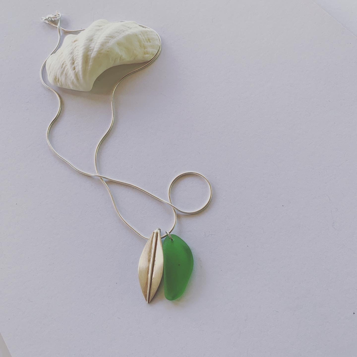 Silver leaf and beach glass pendant. Naturally ocean tumbled beach glass and silver leaf pendant on sterling silver snake chain..... available in 45cm and 50cm sterling silver snake chain. Ocean and Earth🌊🍃 Each piece of natural beach glass may slightly vary, as no piece of beach glass is the same. Unique and of the same quality only the most perfect shaped pieces are used to suit the design and how each piece sits.