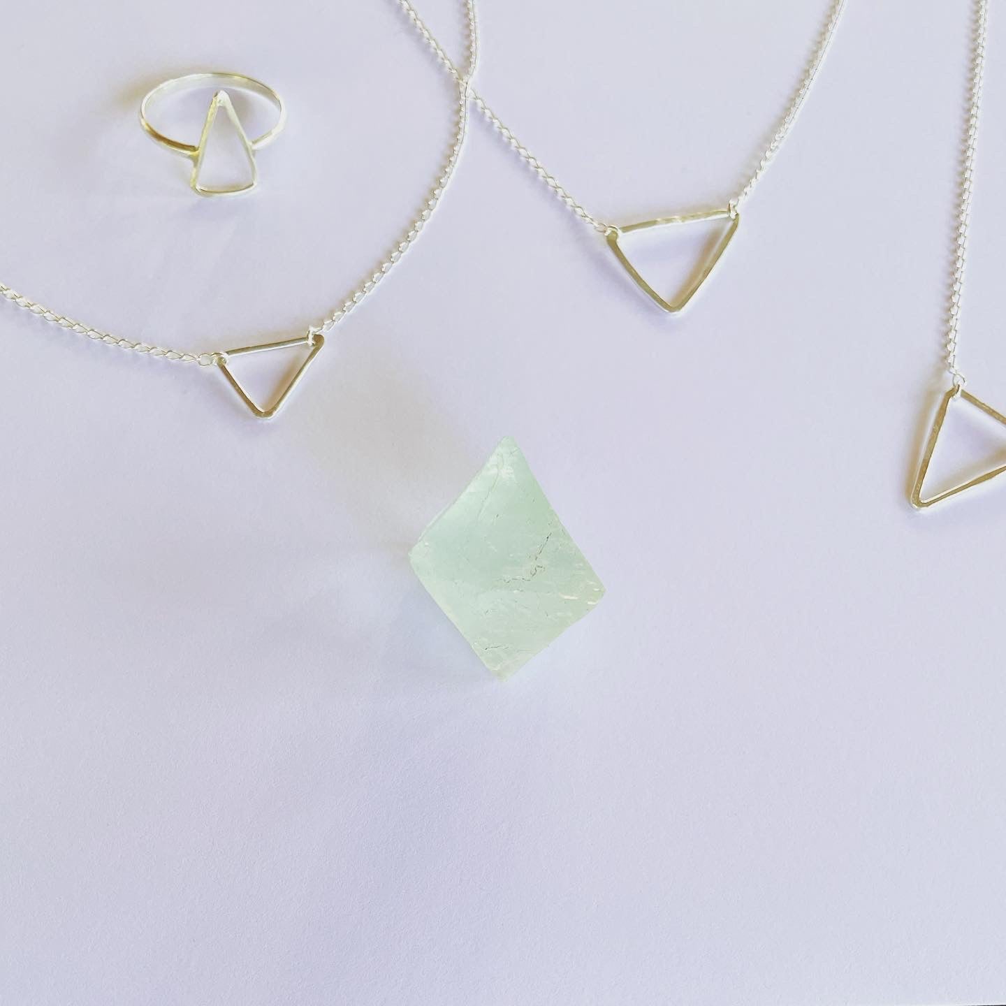 The Trinity pendant, the triangle pendant in silver. Part of our geometric series, half moon, triangle and ring pendant. Connection to our earth and heart space of creation in sacred geometry. A triangle represents manifestation, enlightenment, revelation, and a higher perspective. Energetically, triangles direct energy and power in the direction which they point.