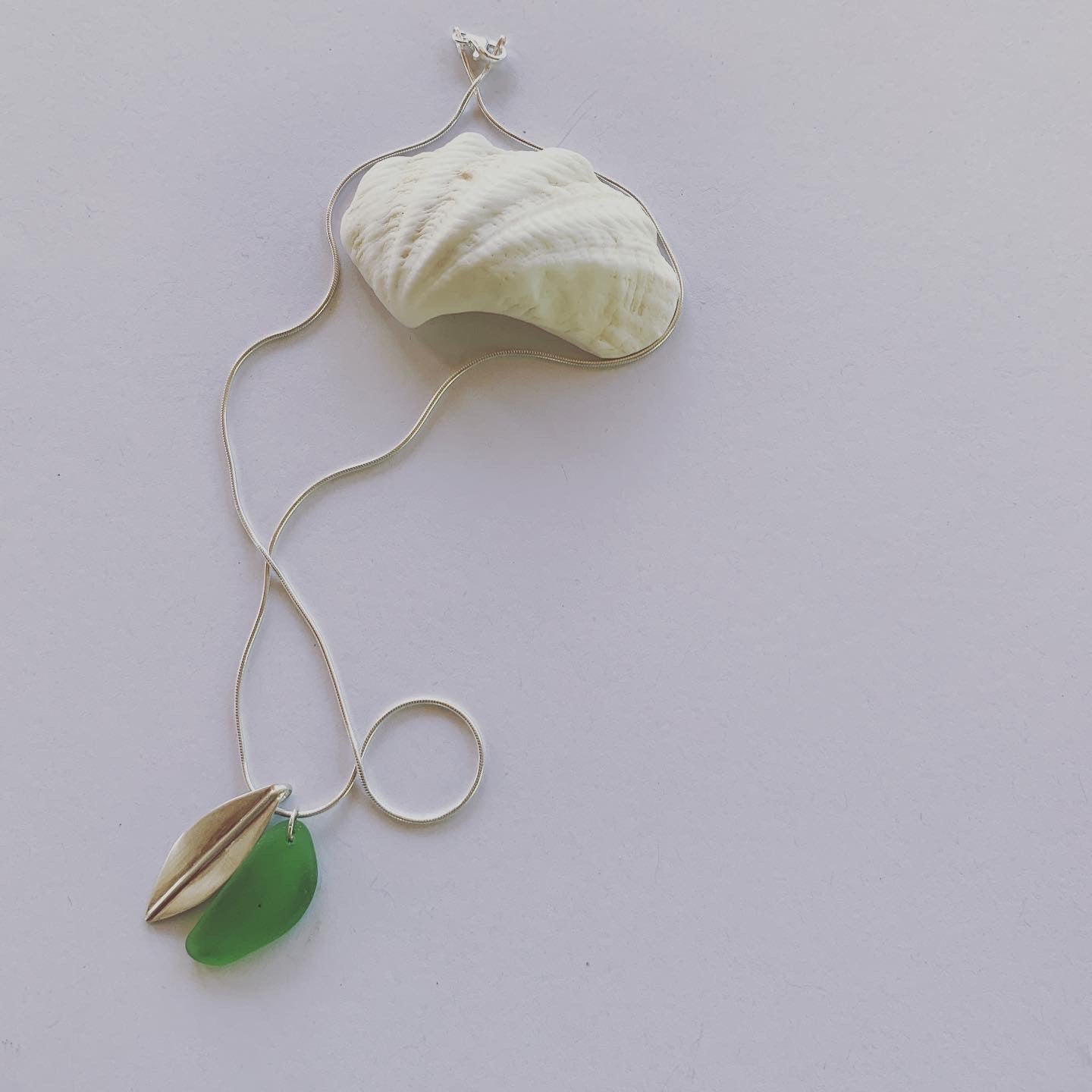 Silver leaf and beach glass pendant. Naturally ocean tumbled beach glass and silver leaf pendant on sterling silver snake chain..... available in 45cm and 50cm sterling silver snake chain. Ocean and Earth🌊🍃 Each piece of natural beach glass may slightly vary, as no piece of beach glass is the same. Unique and of the same quality only the most perfect shaped pieces are used to suit the design and how each piece sits.