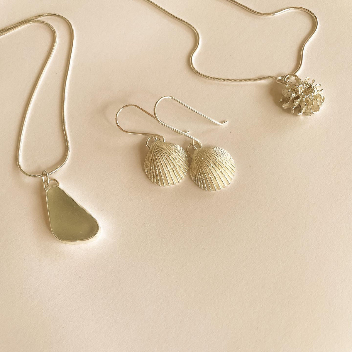 livi shell earrings in silver and sea glass pendant necklace with she oak necklace in silver