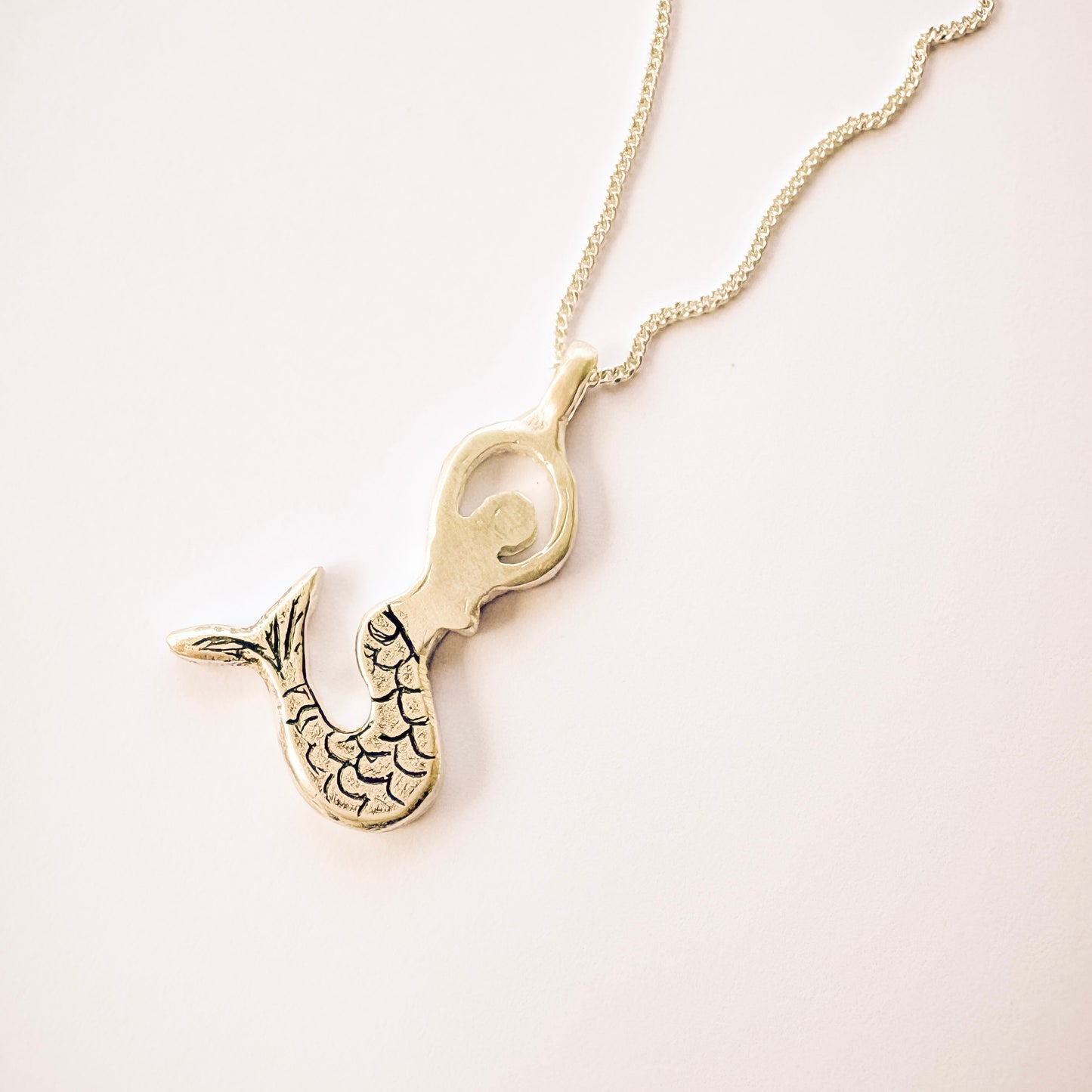 close-up silver mermaid pendant necklace