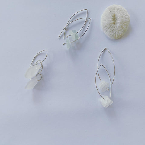 Clear hues sea glass, floating on sterling silver wish bone ear hooks. Sterling Silver Wishbone length 40mm