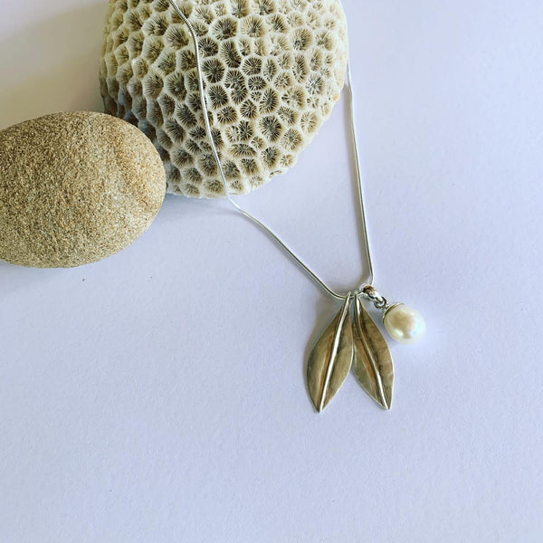 Handmade in silver our special, two leaf and white pearl pendant on sterling silver snake chain.  Available on 45cm and 50cm snake chain.  The charm of earthly delights, where forest and ocean meet, on the gorgeous snake chain🌿