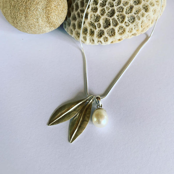 Handmade in silver our special, two leaf and white pearl pendant on sterling silver snake chain.  Available on 45cm and 50cm snake chain.  The charm of earthly delights, where forest and ocean meet, on the gorgeous snake chain🌿