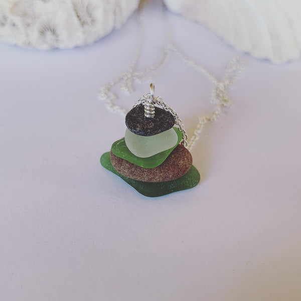 Naturally ocean tumbled beach glass and beach pebble serenity stack on 60cm sterling silver fine chain......  Ocean breath and ocean love earthed in this neck piece.  Balance, calm and centred........  Each piece of natural beach glass may slightly vary, as no piece of beach glass is the same. Unique and of the same quality only the most perfect shaped pieces are used to suit the design and how each piece sits. 