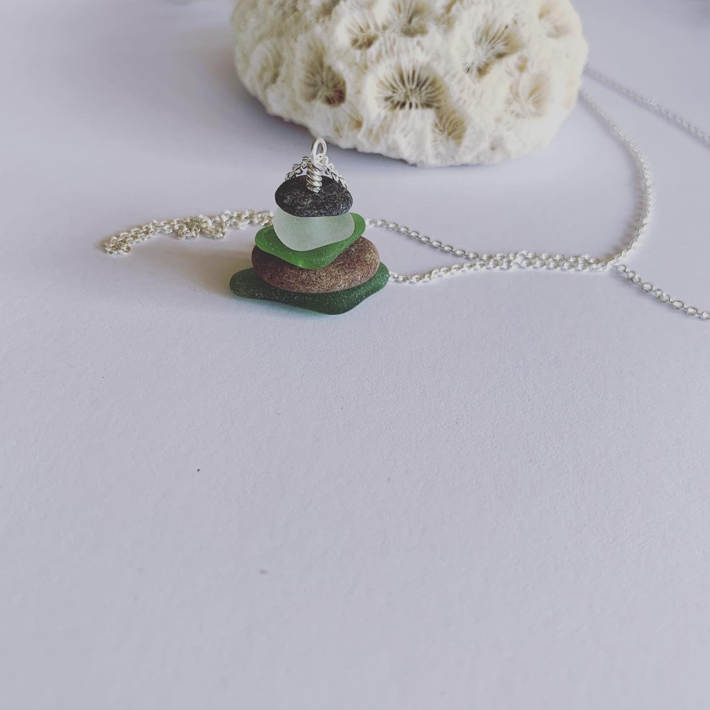 Naturally ocean tumbled beach glass and beach pebble serenity stack on 60cm sterling silver fine chain......  Ocean breath and ocean love earthed in this neck piece.  Balance, calm and feeling centred........  Each piece of natural beach glass may slightly vary, as no piece of beach glass is the same. Unique and of the same quality only the most perfect shaped pieces are used to suit the design and how each piece sits. 