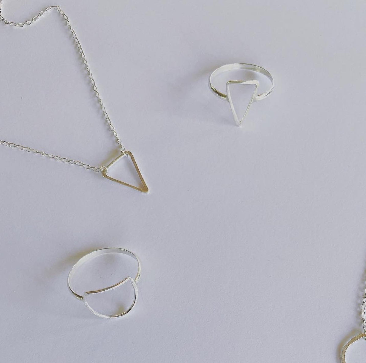 The Trinity pendant, the triangle pendant in silver.  Part of our geometric series, half moon, triangle and ring pendant.  Connection to our earth and heart space of creation in sacred geometry.  A triangle represents manifestation, enlightenment, revelation, and a higher perspective. Energetically, triangles direct energy and power in the direction which they point. 