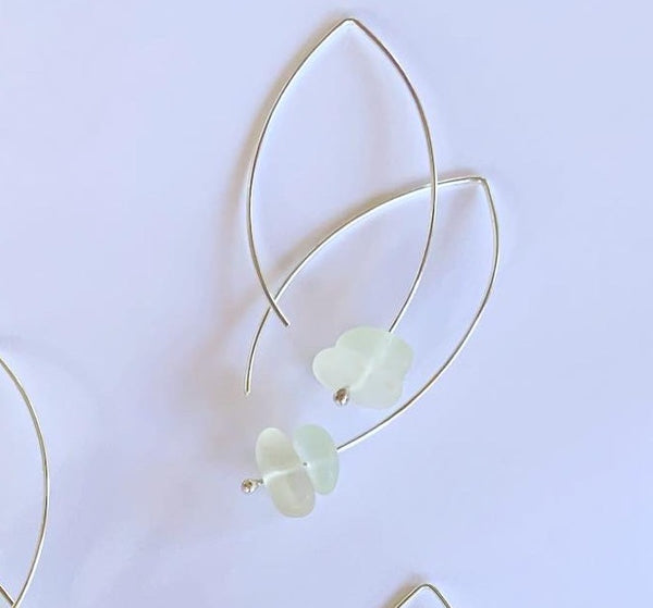 Clear hues sea glass, floating on sterling silver wish bone ear hooks. Sterling Silver Wishbone length 40mm